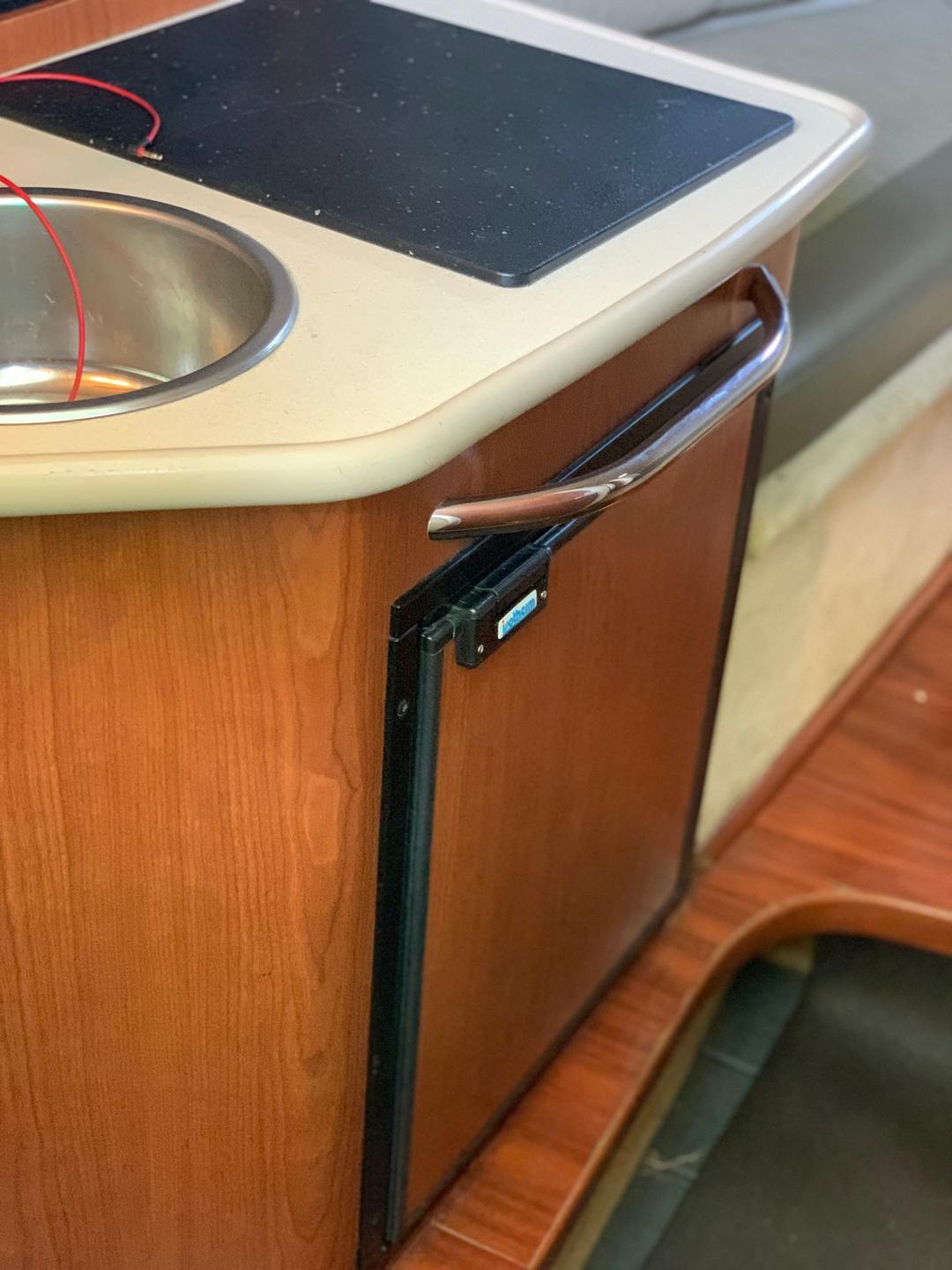 Cabinet space inside a white mini yacht cruiser boat rental at Lake Lewisville