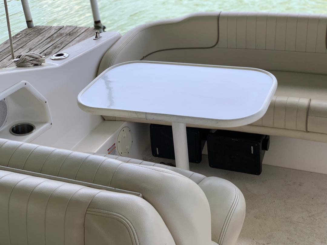 Dining table setup inside a white mini yacht cruiser boat rental at Lake Lewisville