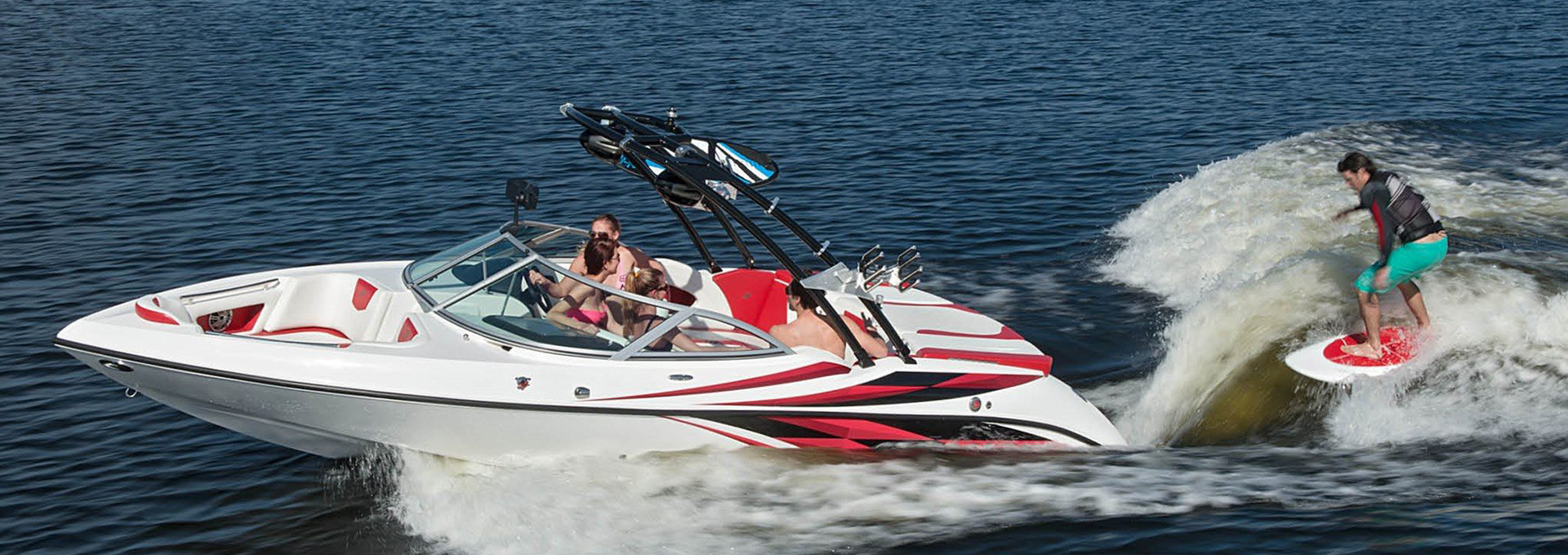 All-Star water sports platoon boat rental at Lake Lewisville with friend skiing in the back